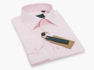 Pink folded men's shirt with long sleeves and buttons on a light background
