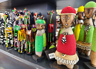 Traditional African wooden hand made dolls and colorful bead decoration at local craft market...