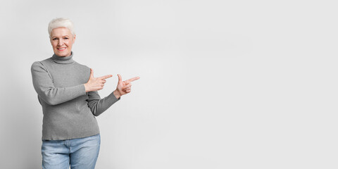 Elderly woman with two thumbs up and a smile
