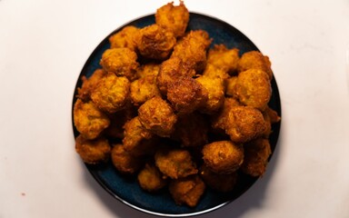 Closeup top view of chicken nuggets in round shape on a black plate, concept of food