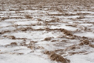 Beautiful shot of the ground of the Death Valley covered in slight snow, California