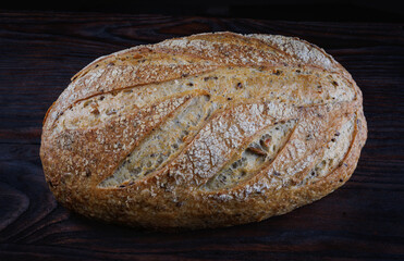 Beautiful loaf of bread on a wooden cutting board. Art bread.