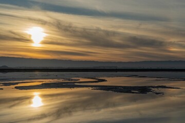 Fototapeta na wymiar Scenic sunset clouds reflecting on the peaceful lake surface