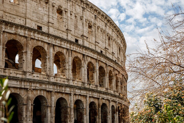 Arches on the facade of the Roman Colosseum in spring.