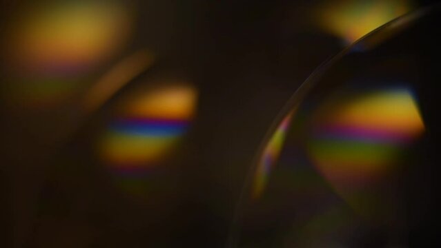 Big soap bubbles shimmering colors of the rainbow against a dark background
