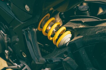 Detailed view of a motorcycle rear suspension under the sunlight