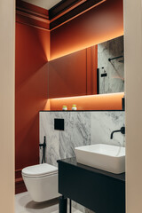 Interior of modern bathroom with red wall and illuminated mirror	
