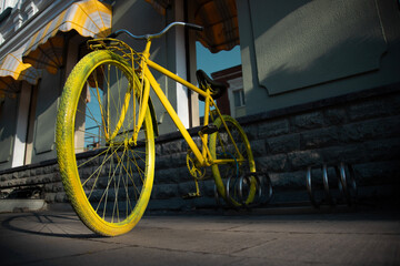 yellow retro bicycle parking against cafe