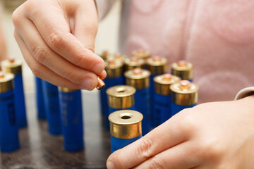 A man make repairing of plastic case for making a cartridges for shooting