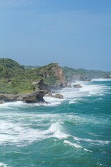 Aerial view of sea waves breaking rocky beach