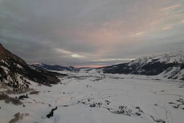 Shot of a mountain range covered with white snow on a sunny day