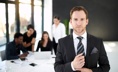 Corporate, portrait of businessman in office with confidence for leader or manager and team in meeting. Pride, smile and man with business people, collaboration and work on startup project or agency