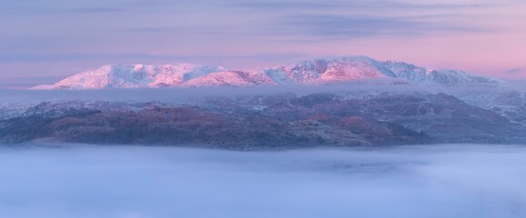 Winter landscape view at sunrise with frozen mountain, snow around