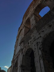 Vertical low-angle shot of a part of the ancient Colosseum