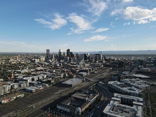 Aerial shot of the modern cityscape of Denver under the blue cloudy sky in Colorado, USA