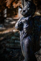 Vertical shot of a statue of an angel in a park
