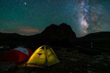 Closeup of tents on a Milky way sky and the Uinta Mountains background