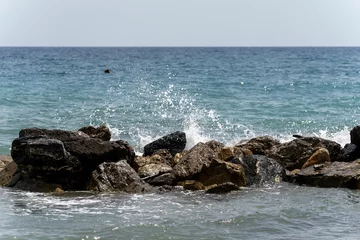 Fototapeten Beautiful view of waves washing the shore in Liguria Italy © Wirestock