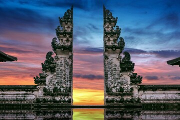 Sunset over Temple gates at Lempuyang Luhur temple in Bali, Indonesia, purple, golden sky background