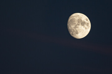 closeup on almost full moon in a dark night sky