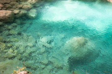 closeup of beautiful turquoise water with limestones background