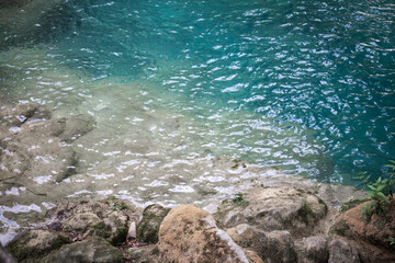 closeup of beautiful clean, transparent water with limestones and rocks