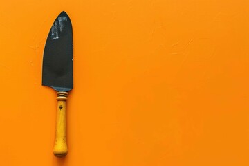 Putty knife on orange background
