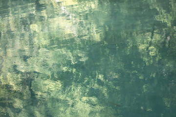 closeup of beautiful clean, transparent water with limestones and rocks