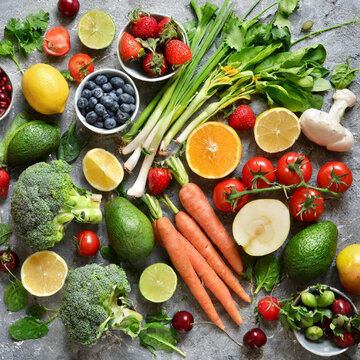 Various fruits and vegetables on grey background