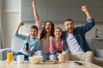 Family celebrates a win while playing video game
