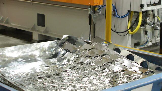 Worker Stacking Sheet Metal In A Bin, Power Press Production