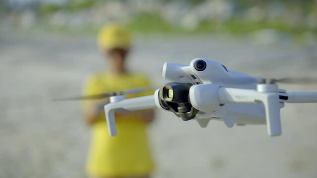 Boy flying a drone in beach side