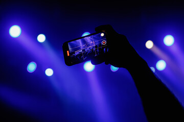 A mesmerizing moment unfolds at a live concert, recorded via mobile phone camera.