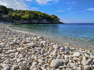 Srebrna beach with white pebbles, turquoise sea and forest in the background. Vis island. Left view