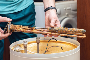 The water heating element of the boiler is covered with sediment and limescale. Boiler repair and...