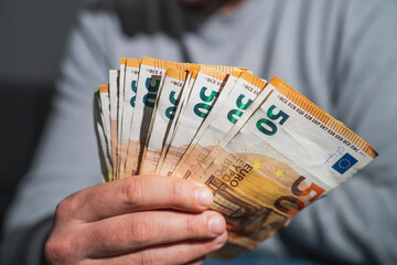 euro bills in male hands