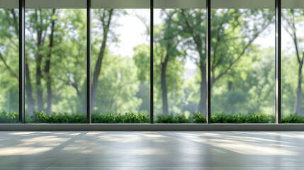 Blurred empty modern open space business office with large windows and green trees on the outside,...