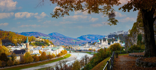 Autumn season at a historic city of Salzburg with Salzach river in beautiful sunset sky and...