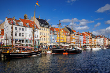Colourful houses and historic boats in Nyhavn, Copenhagen, Denmark.