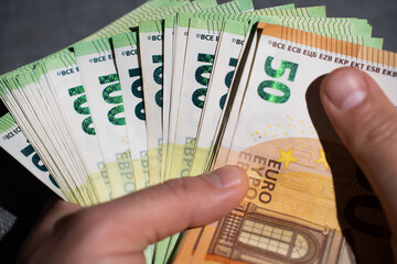 euro bills in male hands