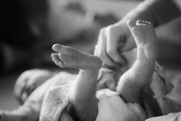 Tiny Steps of Wonder: Adorable Baby Feet Capturing the Essence of New Beginnings in Black and White
