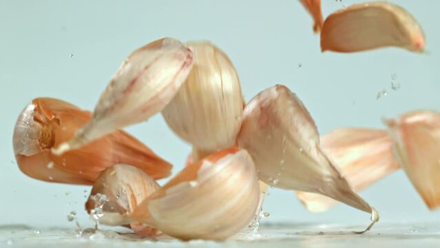 Super slow motion garlic falls on the table. High quality FullHD footage
