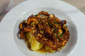 Fried octopus with boiled potatoes, a delicious seafood dish showcasing culinary excellence.