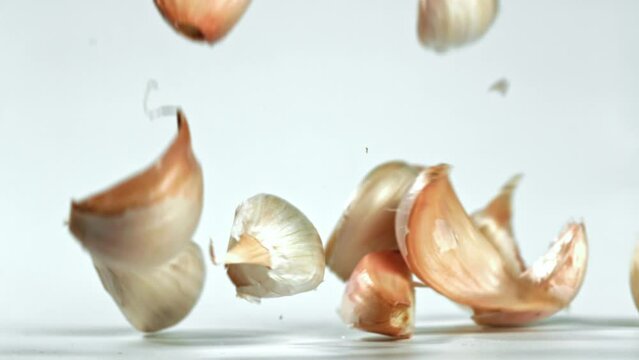 Super slow motion garlic falls on the table. High quality FullHD footage