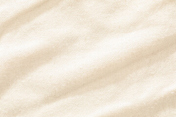 Close-up of a beige fabric showcasing its woven texture and smooth surface.