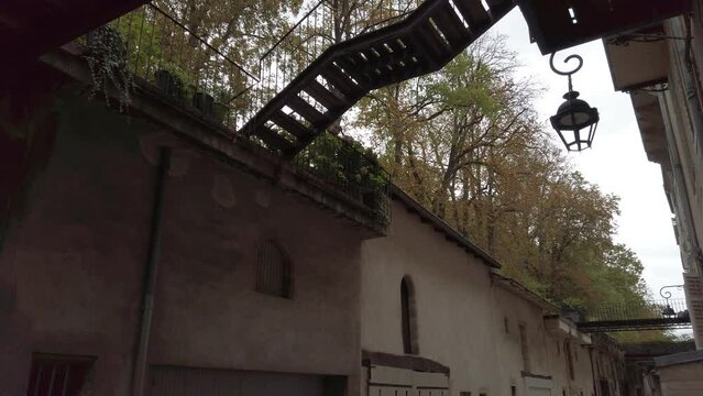 Mysterious Old Alleyway With Iron Lantern and Exterior Staircase in European Town - Nancy France rue des &eacute;curies