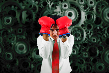 Close up worried businessman in suit with red boxing gloves in blocking boxing position