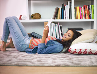 Black girl, relax and happy on floor with tablet for online entertainment, social media or...