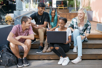 Happy, students and outdoors with laptop on stairs for learning, education and online research for project. Diversity, friends and group with technology for discussion, teamwork and study session - obrazy, fototapety, plakaty