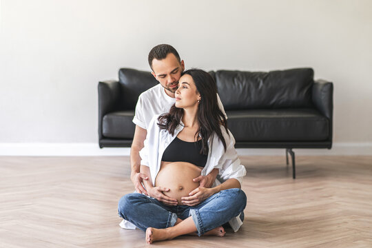 Pregnant woman sitting on floor with husband